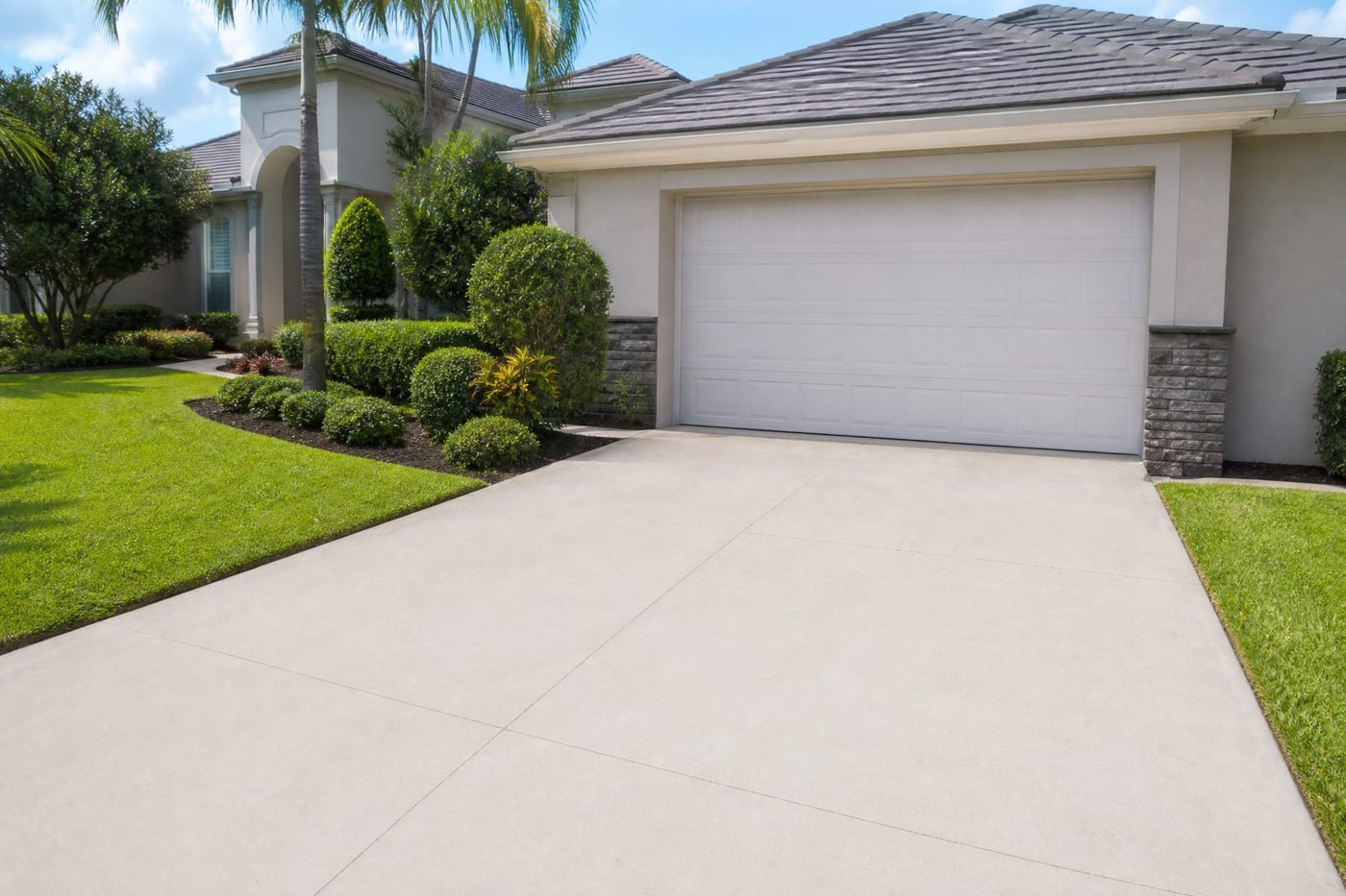 Immaculate white concrete driveway after professional cleaning